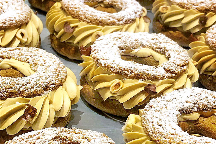 The Paris-Brest is an almond encrusted 'pâte à choux' filled with a praline 'crème mousseline.'