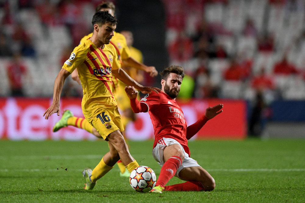 Barcelonau00e2u20acu2122s Pedri vies with Benficau00e2u20acu2122s Rafa Silva during the Uefa Champions League first round group E match between Benfica and Barcelona at the Luz stadium in Lisbon, September 29, 2021. u00e2u20acu201d AFP picnn