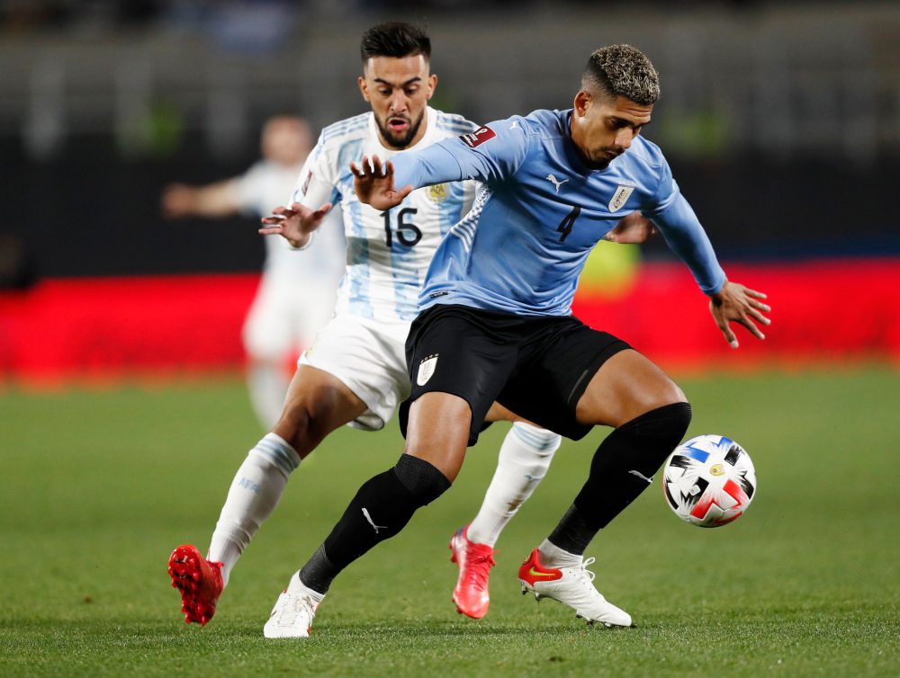 Uruguayu00e2u20acu2122s Ronald Araujo in action with Argentinau00e2u20acu2122s Nicolas Gonzalez during the World Cup South American qualifiers at El Monumental, Buenos Aires, Argentina, October 10, 2021. u00e2u20acu201d Reuters pic 