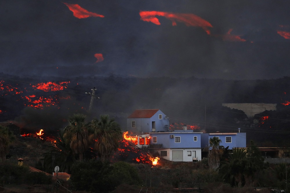 Lava from the Cumbre Vieja volcano burns a house on the Canary Island of La Palma, as seen from Tajuya, Spain, October 19, 2021. u00e2u20acu2022 Reuters pic