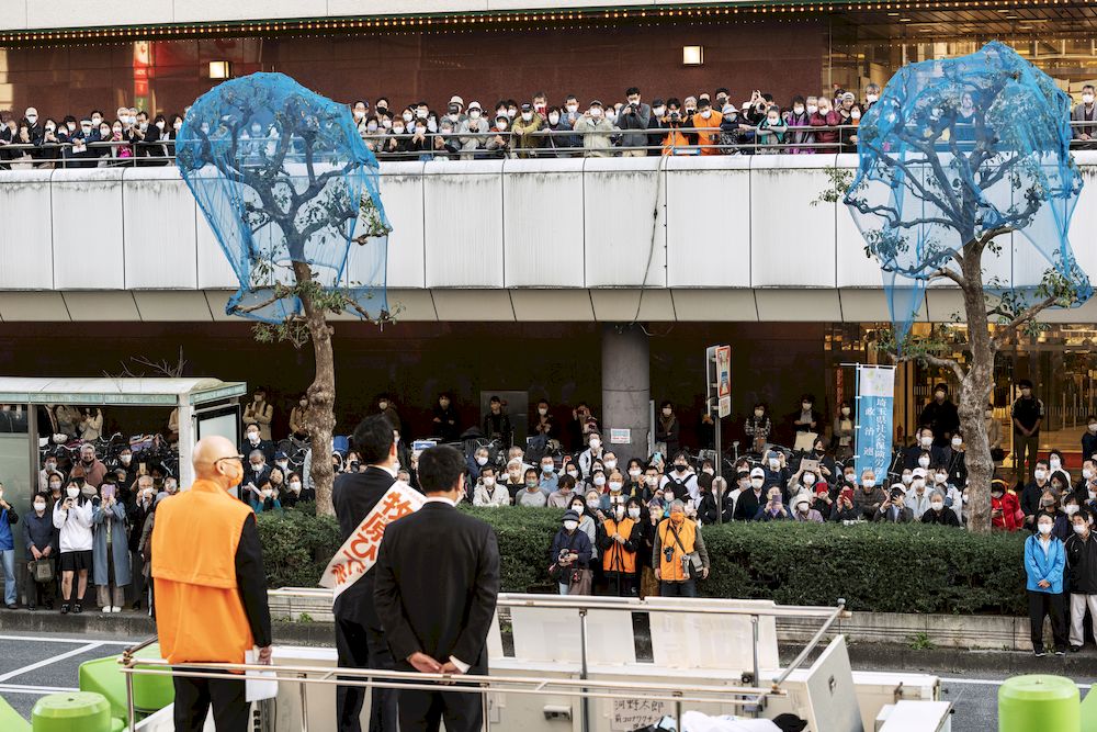 People wearing masks listen to a politician giving a stump speech in Saitama, Oct 29, 2021. u00e2u20acu201d Photo by Yusuke Harada/NurPhoto via Reuters