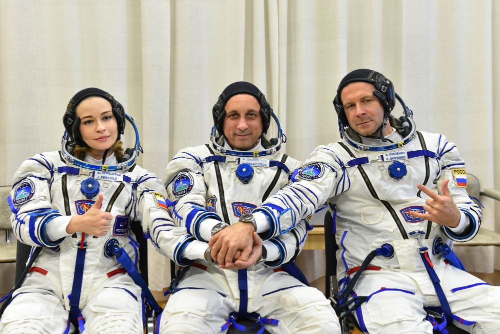 The International Space Station crew members Russian cosmonaut Anton Shkaplerov, film director Klim Shipenko and actor Yulia Peresild pose after donning space suits shortly before the launch at the Baikonur Cosmodrome, Kazakhstan October 5, 2021. 