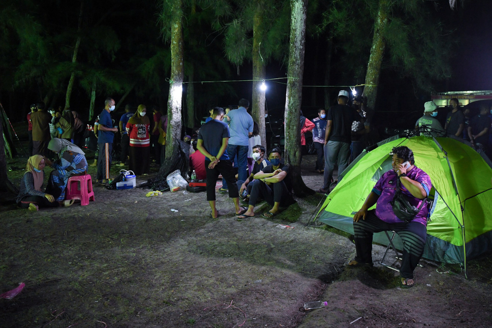 Relatives of the children wait while the search and rescue operation is conducted in Setiu, October 8, 2021. u00e2u20acu201d Bernama pic 