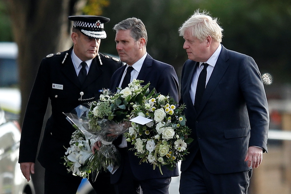 Chief Constable of Essex Police B. J. Harrington, Britainu00e2u20acu2122s Labour Party leader Keir Starmer and Prime Minister Boris Johnson arrive to pay tribute at the scene where British MP David Amess was stabbed to death during a meeting with constituents at the 