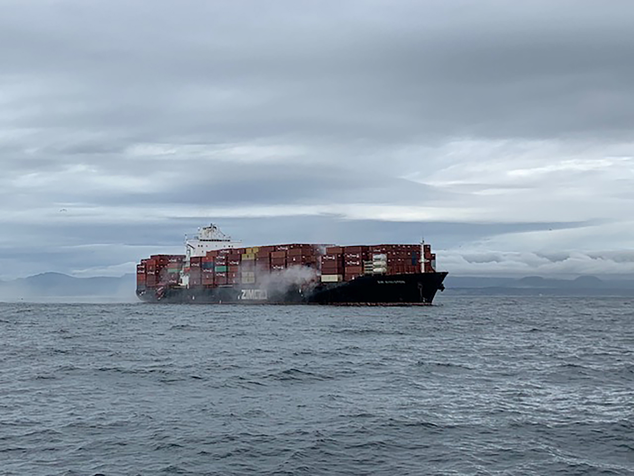 Smoke rises from the container ship Zim Kingston, burning from a fire on board, off the coast of Victoria, British Columbia, Canada October 23, 2021. u00e2u20acu201d Canadian Coast Guard/Handout via Reuters