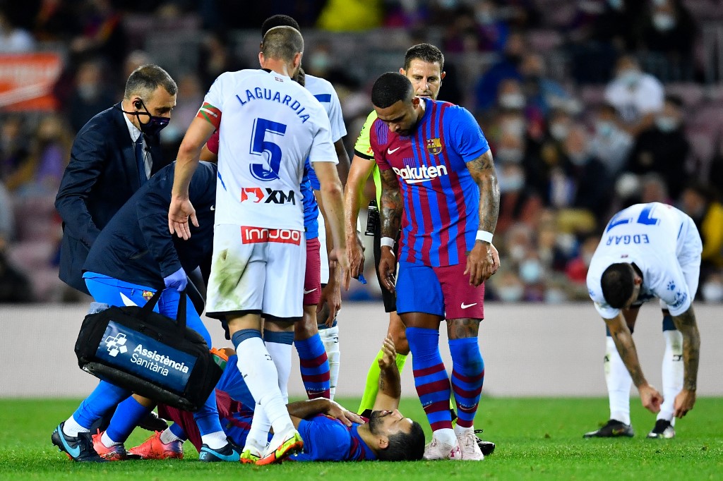 Medics assist Barcelonau00e2u20acu2122s Argentinian forward Sergio Aguero (bottom) after resulting injured during the Spanish League match between FC Barcelona and Deportivo Alaves at the Camp Nou stadium in Barcelona, October 30, 2021. u00e2u20acu201d AFP pic