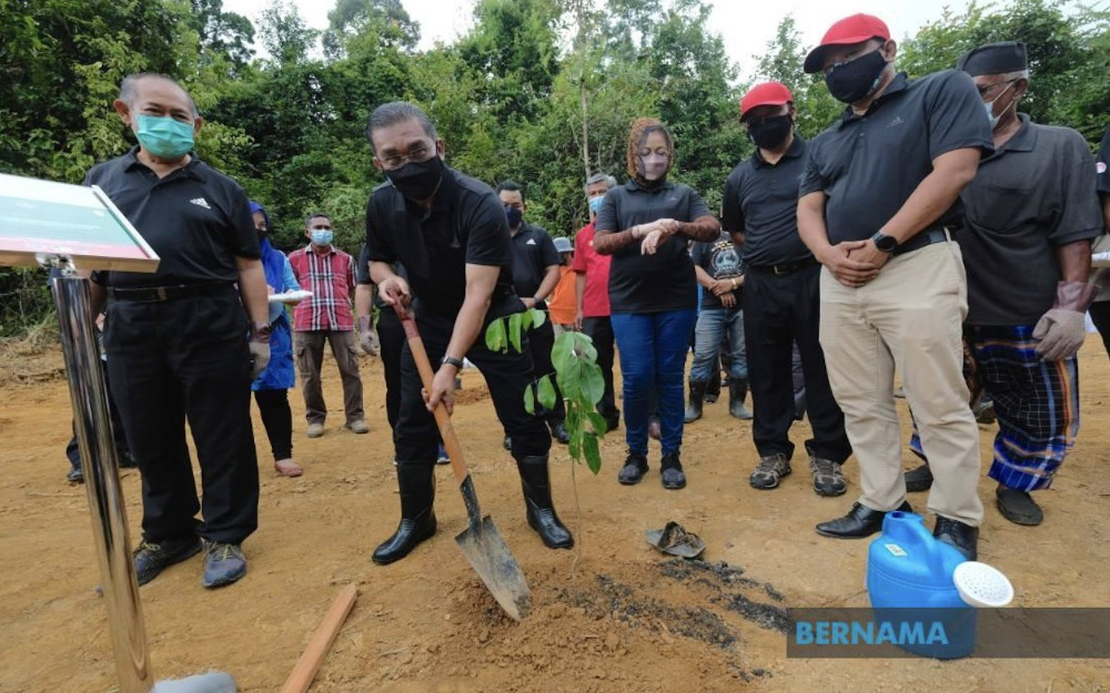 Datuk Seri Takiyuddin Hassan participates in a tree-planting campaign with the community at Kampung Chandek Kura at Compartment 1 of the Bukit Malut Forest Reserve in Langkawi October 17, 2021. u00e2u20acu201d Picture via Twitter/Bernama