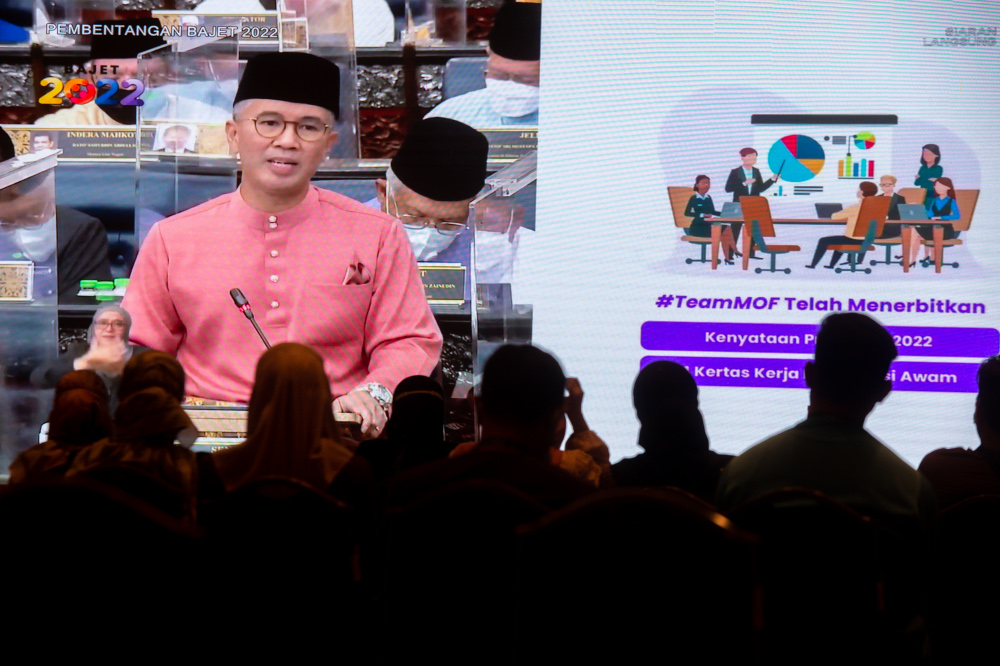 Civil servants watch Finance Minister Datuk Seri Tengku Zafrul Abdul Aziz speak during the tabling of Budget 2022 in the Dewan Rakyat, October 29, 2021. u00e2u20acu201d Picture by Shafwan Zaidon