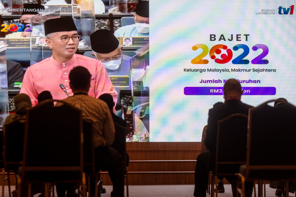 Government servants watch Finance Minister Datuk Seri Tengku Zafrul Abdul Aziz speaking during the tabling of Budget 2022 in the Dewan Rakyat, October 29, 2021. u00e2u20acu201d Picture by Shafwan Zaidon