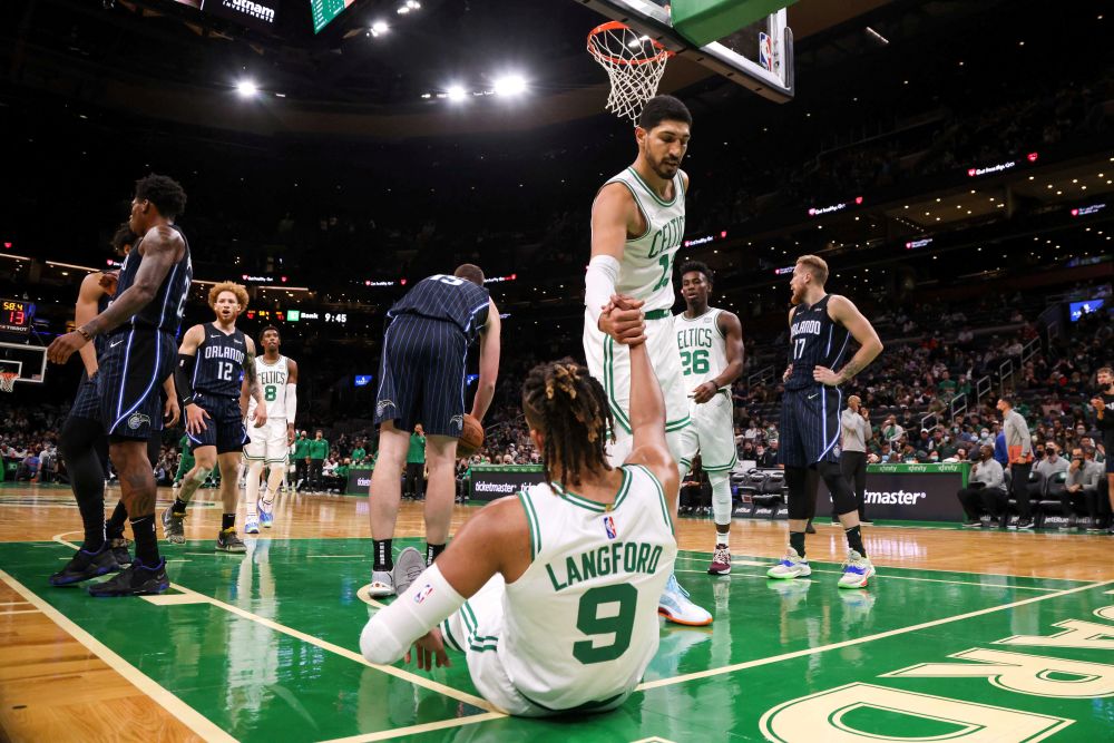 Boston Celtics centre Enes Kanter (13) helps up guard Romeo Langford (9) during the second half against the Orlando Magic at TD Garden, Massachusetts October 4, 2021. u00e2u20acu201d Reuters picnn