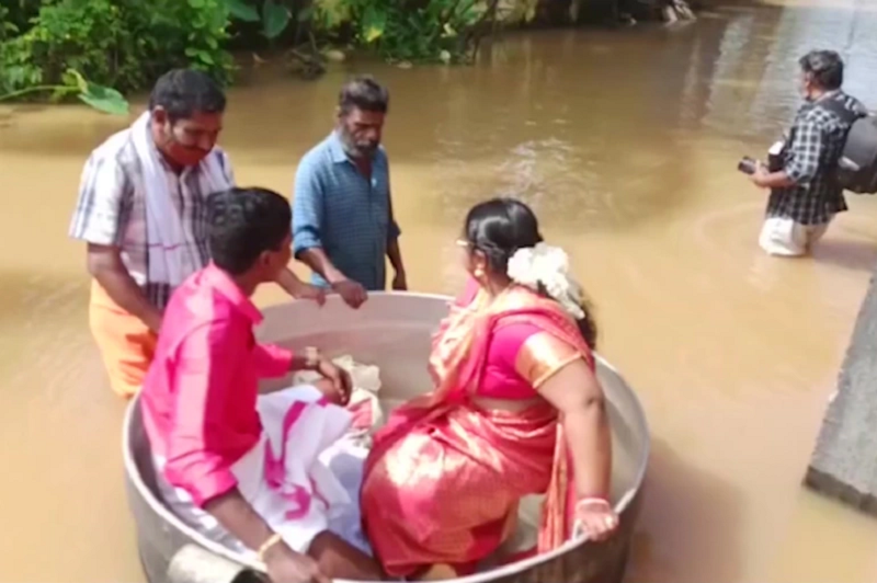 Due to flooding, a couple in Kerala, India had to travel to their wedding venue in a cooking pot. u00e2u20acu2022 AFP pic