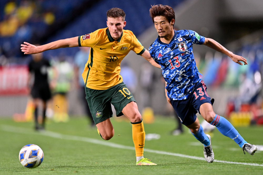 Australiau00e2u20acu2122s midfielder Ajdin Hrustic and Japanu00e2u20acu2122s midfielder Hidemasa Morita fight for the ball during the 2022 Qatar World Cup Asian Qualifiers group B football match between Japan and Australia, at Saitama Stadium in Saitama, October 12, 2021. u00e2u20acu201d AF