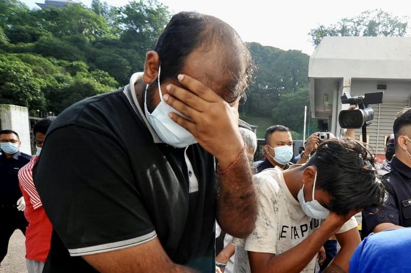 Policeman C. Harethaess (left) and teenager P. Darshan were charged in the Magistrates Court in Johor Baru with drug trafficking today.u00e2u20acu201d Picture by Ben Tannn