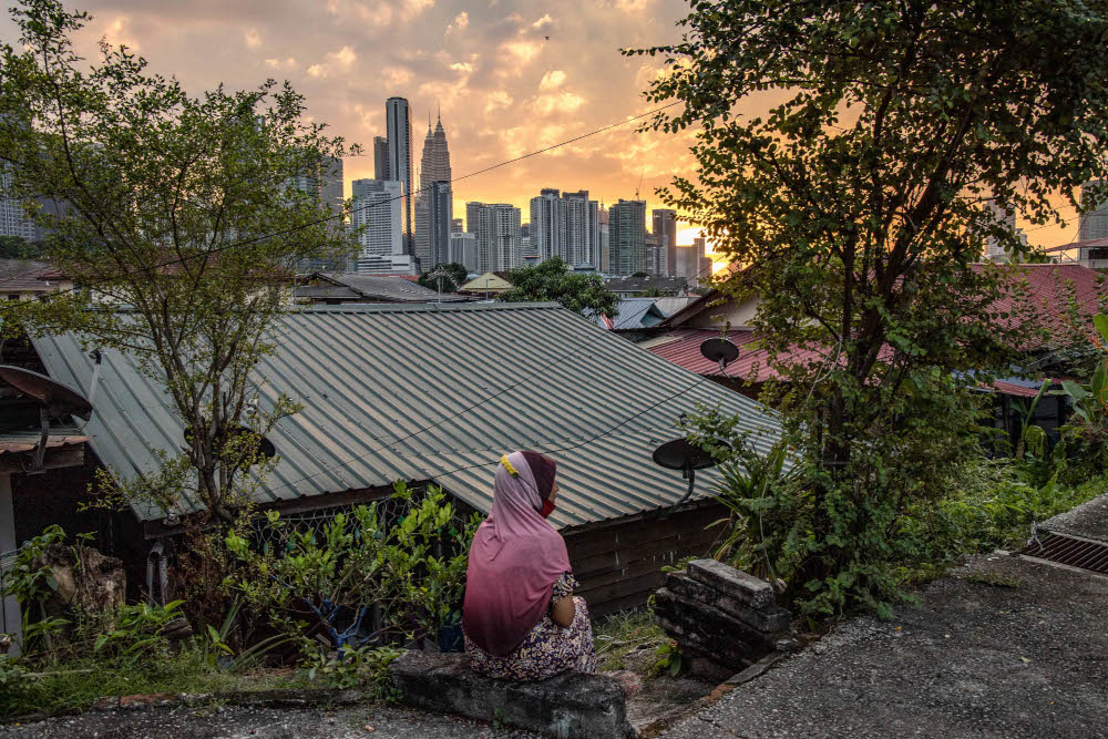 A woman seen enjoying the sunset at her house in Kampung Datuk Keramat, Kuala Lumpur, October 28, 2021. u00e2u20acu201d Picture by Firdaus Latif