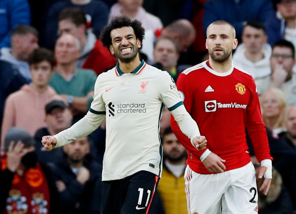 Manchester Unitedu00e2u20acu2122s Luke Shaw looks dejected as Liverpoolu00e2u20acu2122s Mohamed Salah celebrates scoring their fourth goal at Old Trafford, Manchester, Britain, October 24, 2021. u00e2u20acu201d Reuters pic 