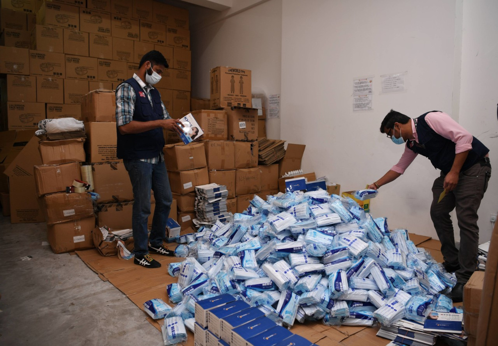 Officers from the Medical Device Authority inspecting the seized medical face masks in Bukit Rimau, October 6, 2021. u00e2u20acu201d Bernama pic 