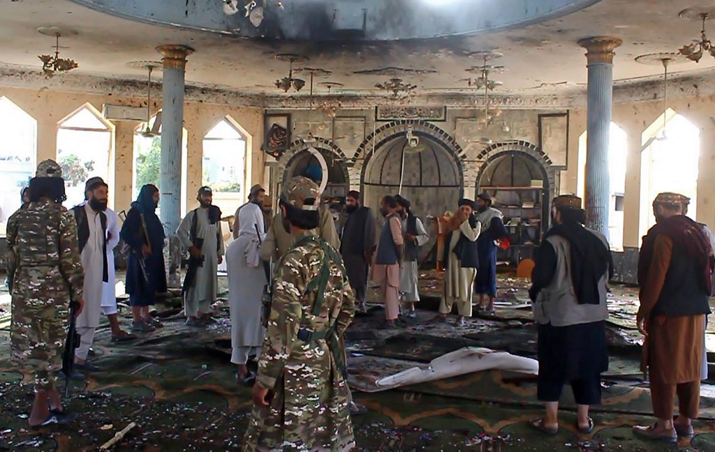 Taliban fighters investigate inside a Shiite mosque after a suicide bomb attack in Kunduz on October 8, 2021. u00e2u20acu201d AFP pic