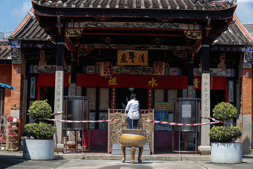 A woman is seen praying at the Snake Temple in Bayan Baru, Penang October 15, 2021. u00e2u20acu2022 Picture by Sayuti Zainudin