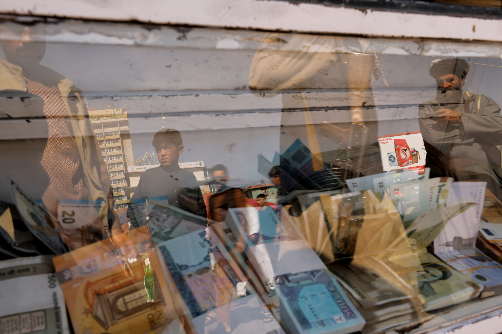 Taliban soldiers are seen reflected in the glass wall of a currency exchange stall in Kabul October 7, 2021. u00e2u20acu201d Reuters pic