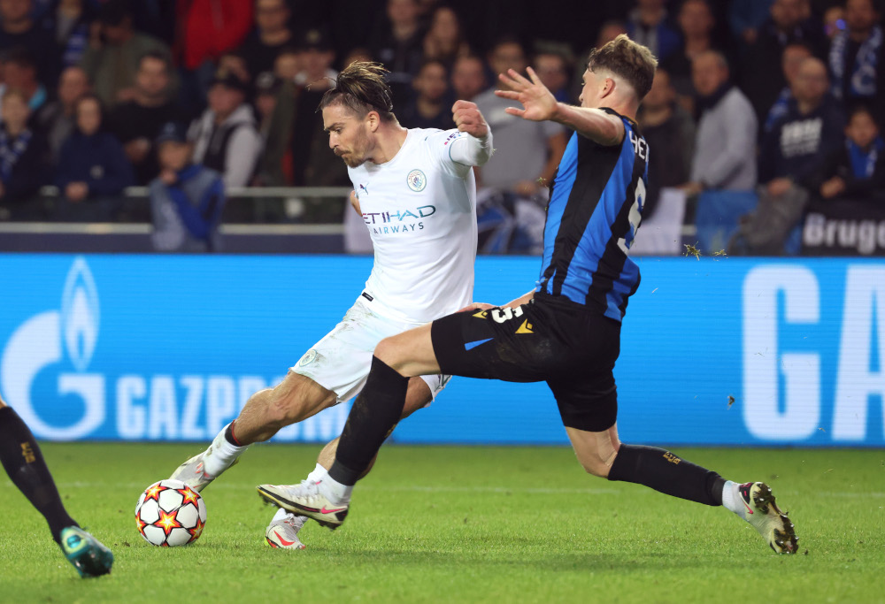 Manchester Cityu00e2u20acu2122s Jack Grealish in action with Club Bruggeu00e2u20acu2122s Jack Hendry during their Champions League Group A match in Jan Breydel Stadium, Bruges October 19, 2021. u00e2u20acu201d Reuters pic