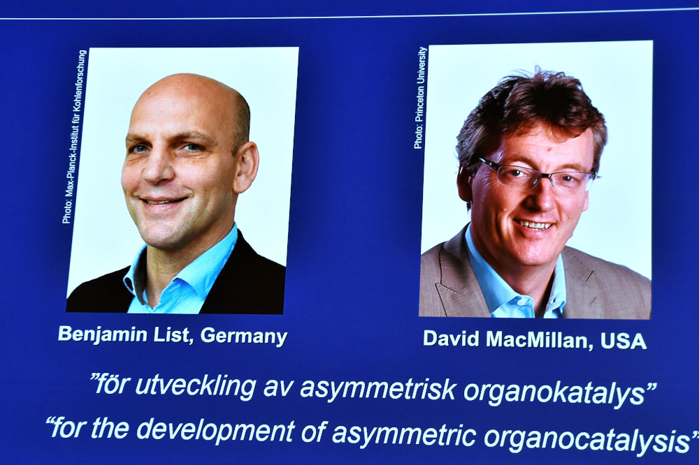 Pictures of the winners of the 2021 Nobel Prize in Chemistry Benjamin List and David MacMillan are seen on a screen during The Royal Swedish Academy of Sciencesu00e2u20acu2122 announcement in Stockholm October 6, 2021. u00e2u20acu201d Claudio Bresciani/TT News Agency pic via Reu
