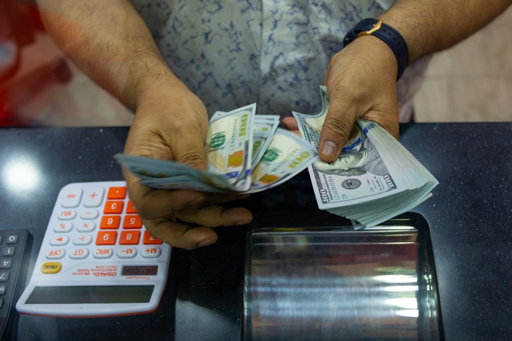 A money changer counts US dollar notes in Kuala Lumpur October 29, 2021. u00e2u20acu201d Picture by Shafwan Zaidon