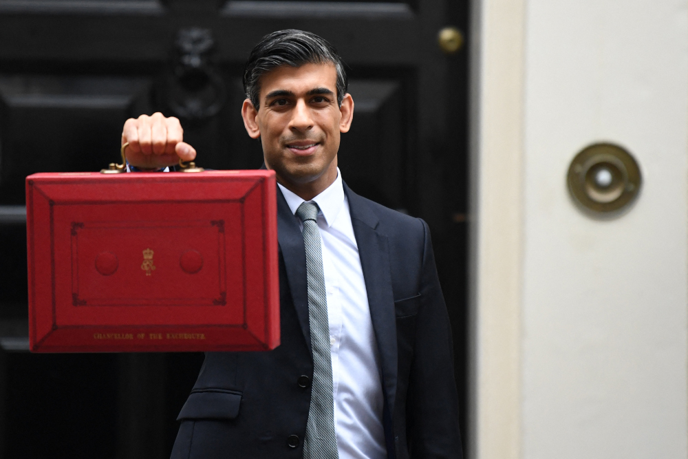 Britainu00e2u20acu2122s Chancellor of the Exchequer Rishi Sunak poses with the Budget Box as he leaves 11 Downing Street in central London October 27, 2021 to present the governmentu00e2u20acu2122s annual budget to Parliament. u00e2u20acu201d AFP picnn
