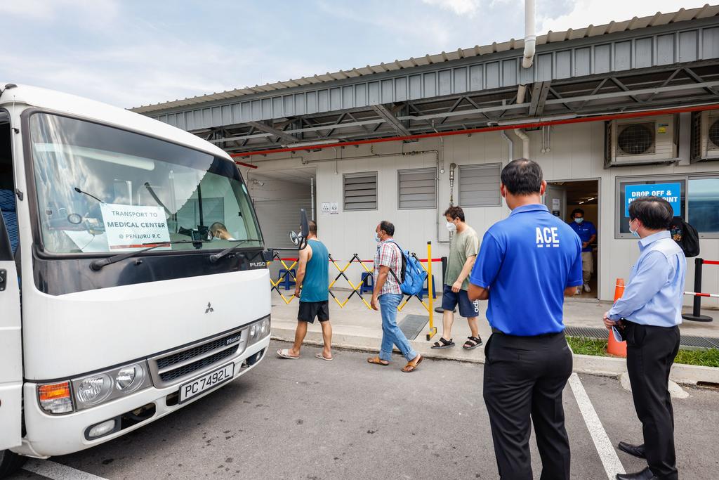 Workers residing at Westlite Jalan Tukang dormitory in Jurong being taken by transport to get medical consultations at a regional medical centre. u00e2u20acu2022 TODAY pic