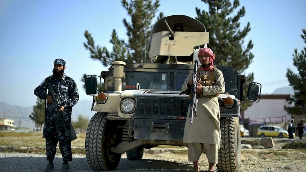 Taliban fighters working as a police force stand guard next to a Humvee vehicle at the entrance gate of a police district in Kabul on October 3, 2021. u00e2u20acu201d AFP pic