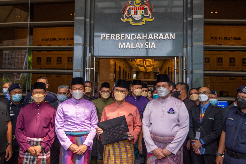 Finance Minister Datuk Seri Tengku Zafrul Abdul Aziz with the Budget 2022 report at the Finance Ministry, October 29, 2021. u00e2u20acu201d Picture by Shafwan Zaidon