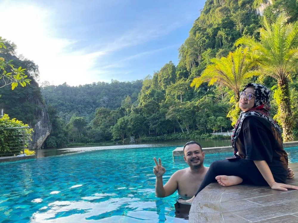 Guests relaxing at the swimming pool built close a natural lake at The Haven All Suite Resort in Ipoh. ― Picture courtesy of The Haven All Suite Resort