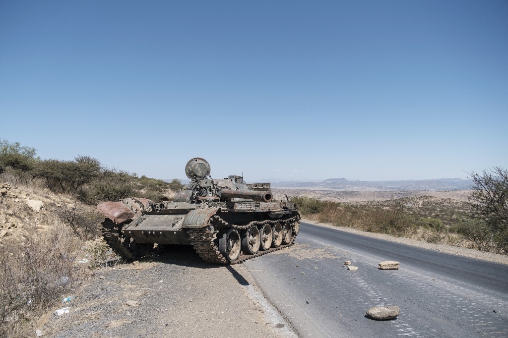 In this file photo taken on February 26, 2021 A damaged tank stands on a road north of Mekele, the capital of Tigray. The Ethiopian government said it had carried out a new air strike on October 20, 2021 against rebel targets in an area of Tigray west of 