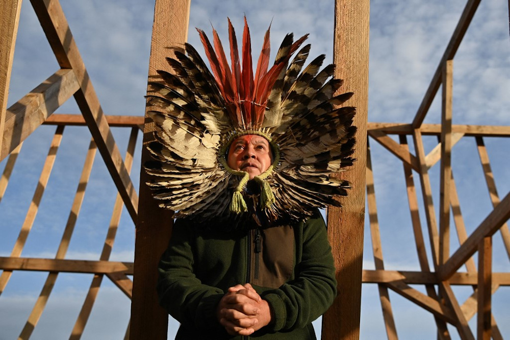Leader of the Kaingang people of Brazil, Kreta Kaingang is seen during a ceremony at a wooden arch built from locally sourced larch on the Cowal peninsula in Scotland on November 4, 2021, on the sidelines of the COP26 UN Climate Change Conference. u00e2u20acu201d AFP