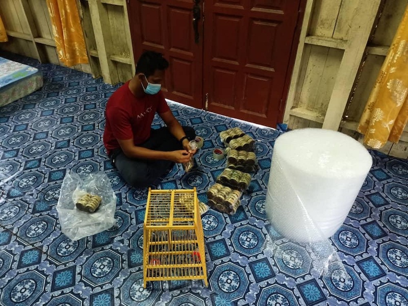Nik Mohd Izahar, 30, of Izahar Shop packs his parcels carefully before sending them out for delivery. — Picture courtesy of Shopee