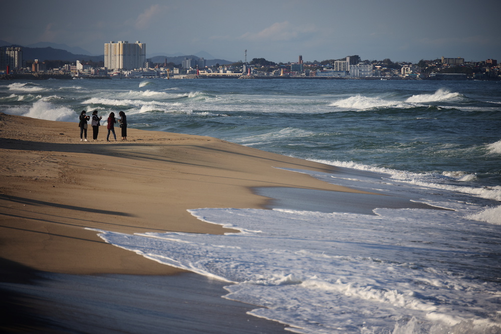 People stand at erosion-affected Sacheon beach where there used to be a long sand beach, in Gangneung, South Korea November 3, 2021. u00e2u20acu201d Reuters pic