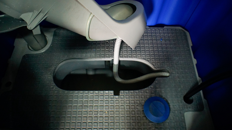 The 270-litre sewage tank inside a squatting-type portable toilet along with its foot pedal for flushing. — Picture by Arif Zikri 