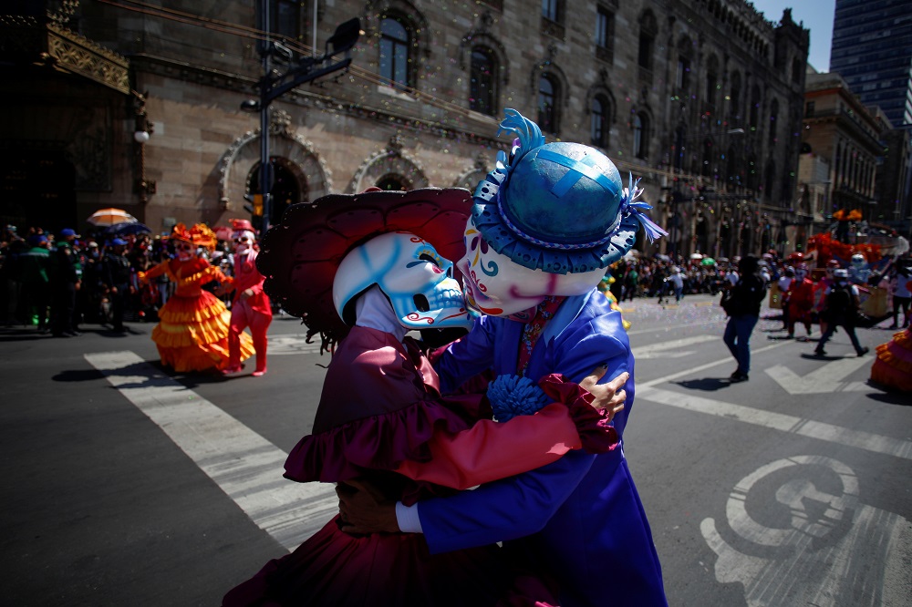 Participants dressed as Catrinas kiss while performing during the annual Day of the Dead parade in Mexico City October 31, 2021. u00e2u20acu201d Reuters pic