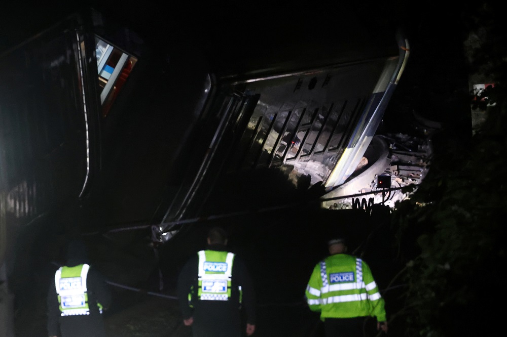 Police officers inspect the site where two trains collided near Salisbury, Britain, early November 1, 2021. u00e2u20acu201d Reuters pic
