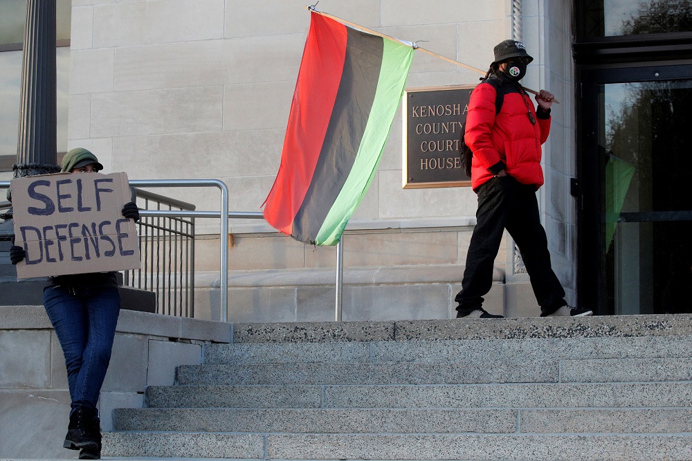 A supporter of Kyle Ritten house and Justin Blake, uncle of Jacob Blake, demonstrate on the steps outside The Kenosha County Courthouse, during the Kyle Rittenhouse trial in Kenosha, Wisconsin November 2, 2021. u00e2u20acu201d Reuters pic
