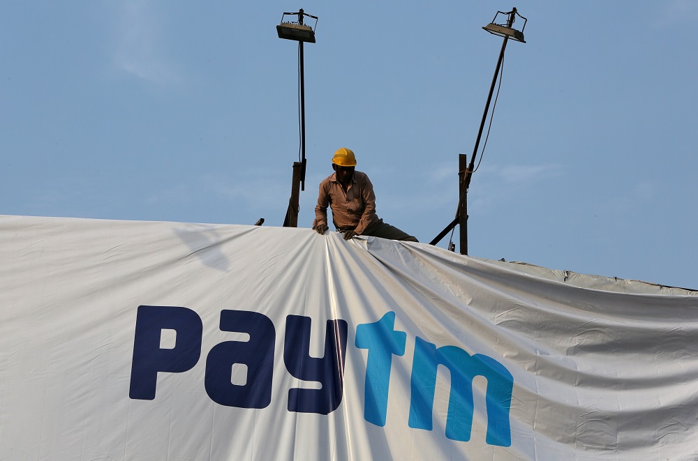 A worker adjusts a hoarding of Paytm, a digital payments firm, in Ahmedabad, India, January 31, 2019. u00e2u20acu201d Reuters pic
