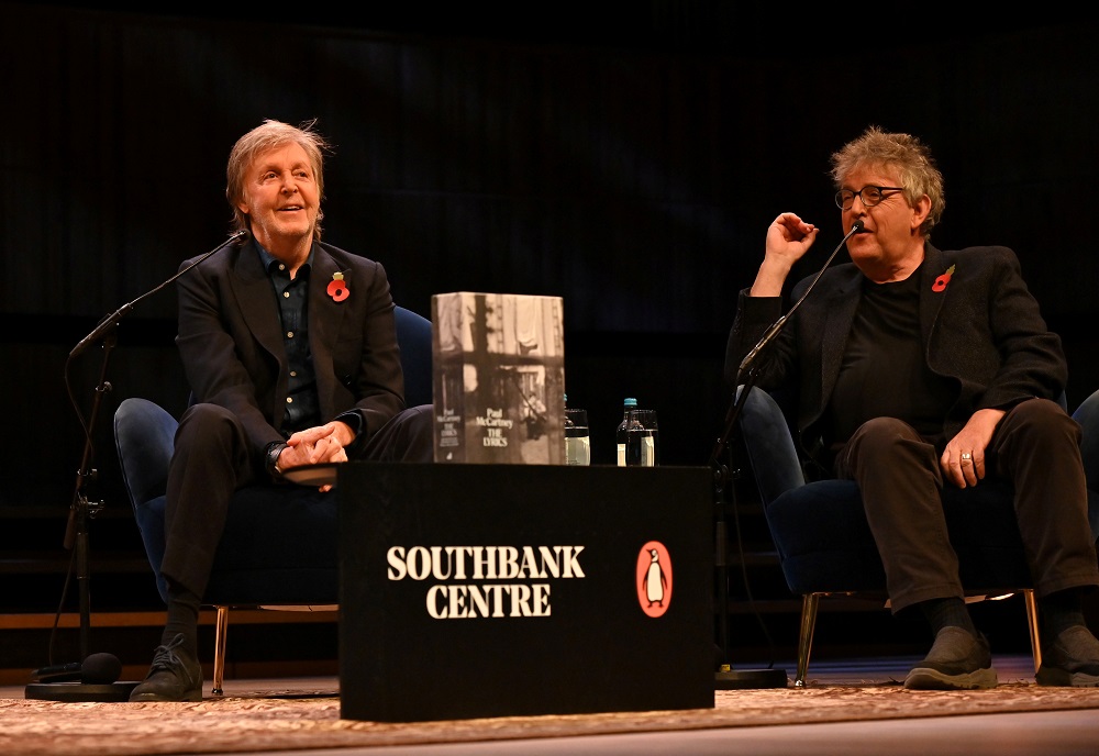 Paul McCartney (left) is seen on stage in conversation with Paul Muldoon (editor) and Samira Ahmed (unseen) in London, Britain, November 5, 2021. u00e2u20acu201d Picture courtesy MPL Communications/Mark Allan/Handout via Reuters