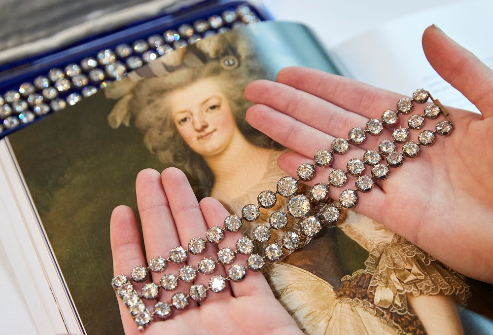 A staff diplays a pair of diamond bracelets, with approximately 140 to 150 carats and owned by Queen Marie-Antoinette, in silver and yellow gold, circa 1776, during a preview at Christieu00e2u20acu2122s before their auction sale in Geneva November 3, 2021. u00e2u20acu201d Reuter