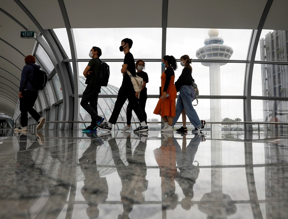 People pass the control tower of Changi Airport in Singapore January 18, 2021. u00e2u20acu201d Reuters pic