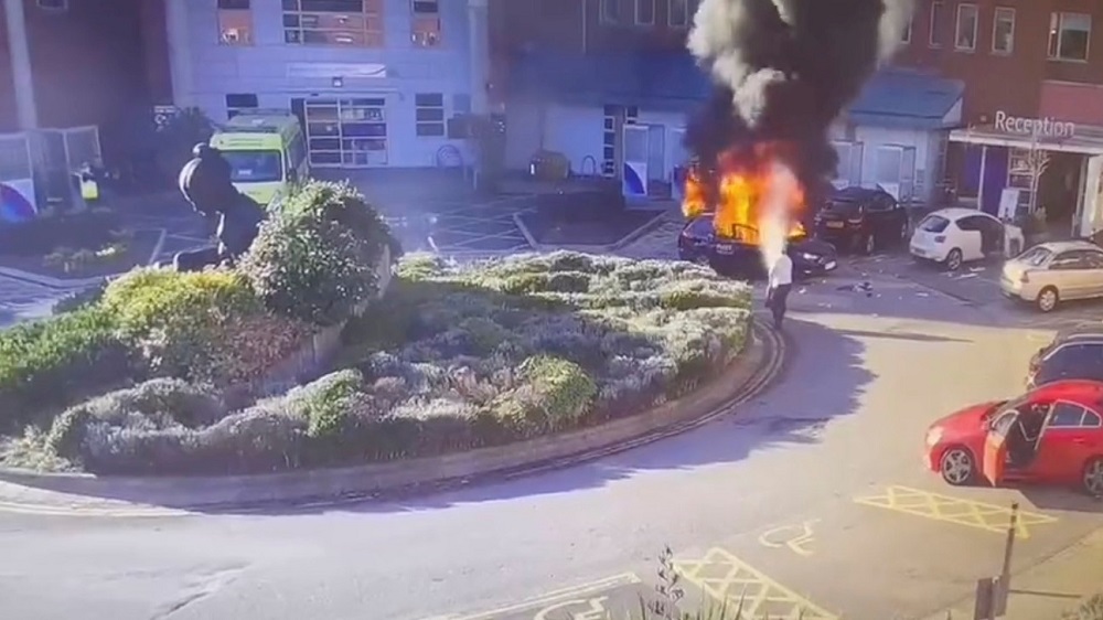 A surveillance camera footage shows a man extinguishing a burning taxi following an explosion outside Liverpool Womenu00e2u20acu2122s hospital in Liverpool November 14, 2021 in this still image obtained from a video on November 15, 2021. u00e2u20acu201d CCTV pic via Reuters