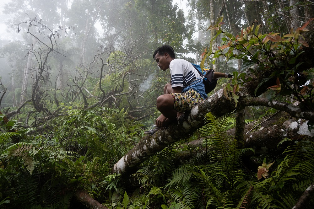Musdi Siraju,19, rests on the way down from Mount Kie Besi on Makian island, North Maluku province, Indonesia, on June 5, 2021. u00e2u20acu201d Picture by Thomson Reuters Foundation/Harry Jacques