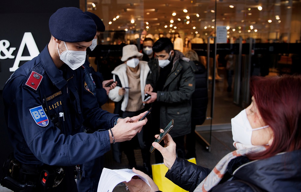 Police officers check the vaccination status of shoppers against the coronavirus disease at the entrance of a store in Vienna, Austria November 16, 2021. u00e2u20acu201d Reuters pic