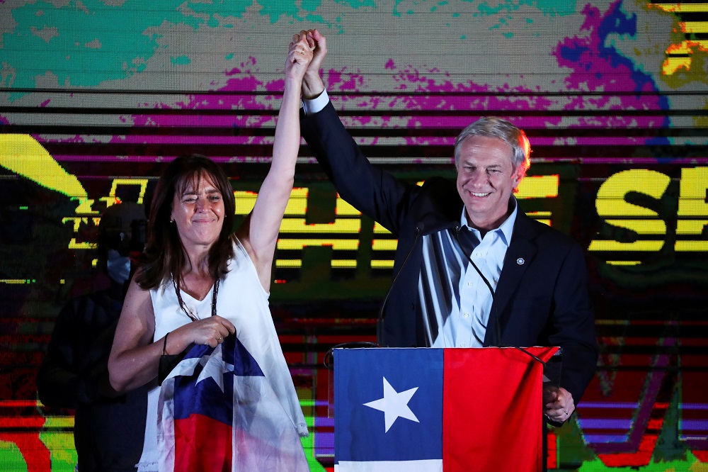 Chilean presidential candidate Jose Antonio Kast and his wife Maria Pia Adriasola Barroilhet raise their hands as he speaks after the partial results of the first round vote during the presidential elections, in Santiago November 21, 2021. u00e2u20acu201d Reuters pic
