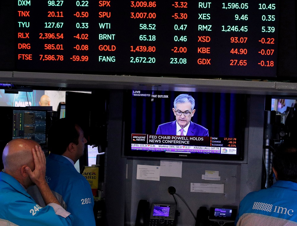 Traders look on as a screen shows Federal Reserve Chairman Jerome Powell's news conference after the US Federal Reserve interest rates announcement on the floor of the New York Stock Exchange July 31, 2019. u00e2u20acu201d Reuters pic