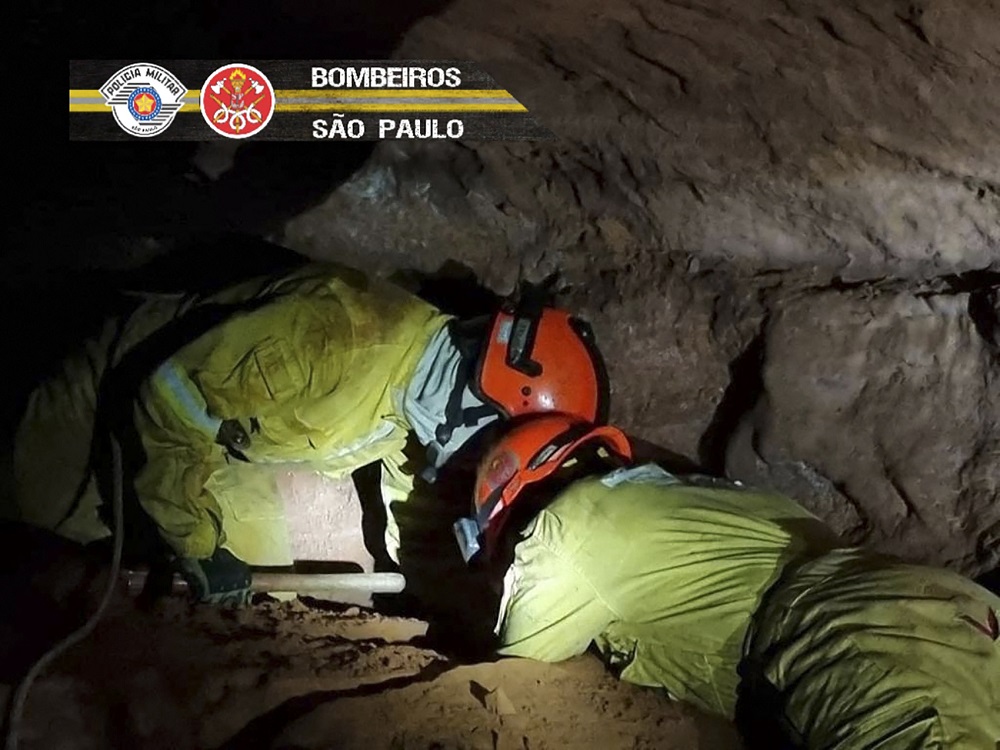 Handout picture showing firefighters working to rescue civilian firefighters buried in a cave after a collapse in Altinopolis, Sao Paulo state, Brazil October 31, 2021. u00e2u20acu201d Handout by Sao Paulo Stateu00e2u20acu2122s Military Police via AFP
