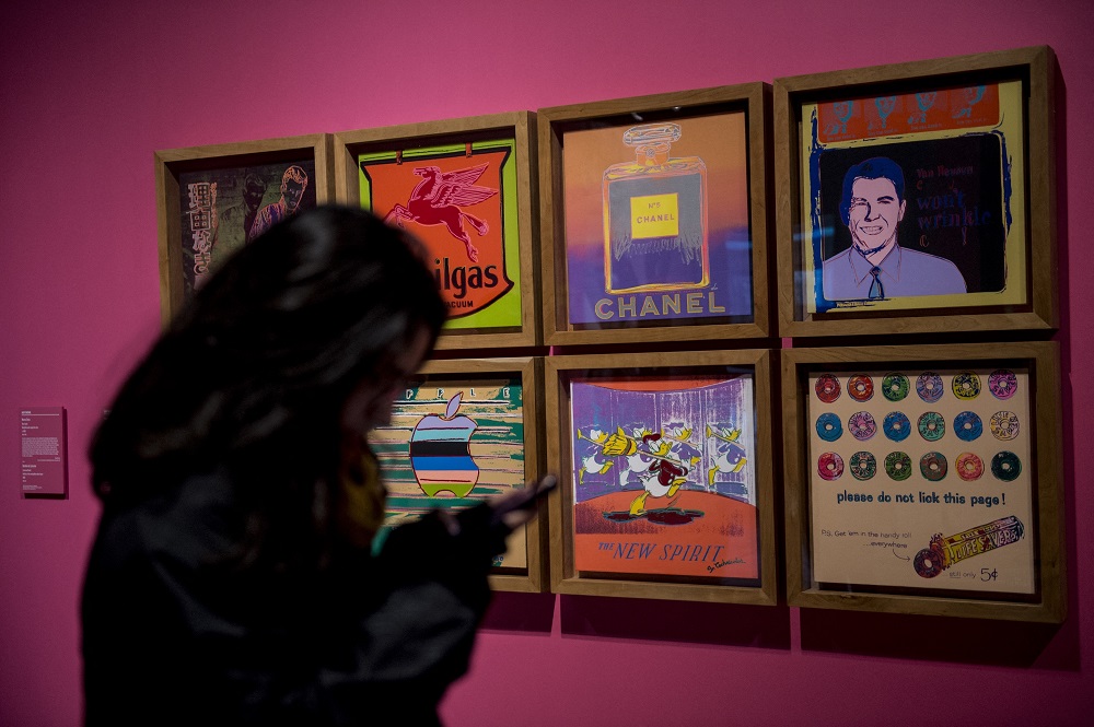A woman visits an exhibition of legendary US pop artist Andy Warhol at the La Moneda Museum in Santiago. u00e2u20acu201d AFP pic
